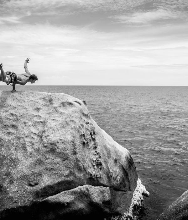 Man in a controlled strength pose in a calm environment.