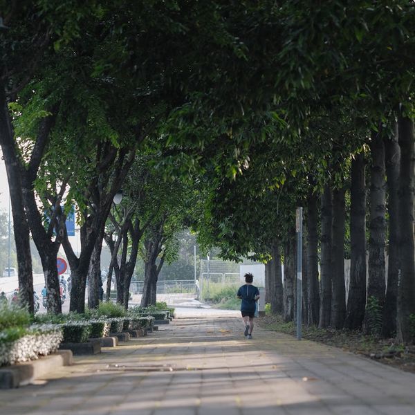 Man outdoors looking serene and energized after a workout.